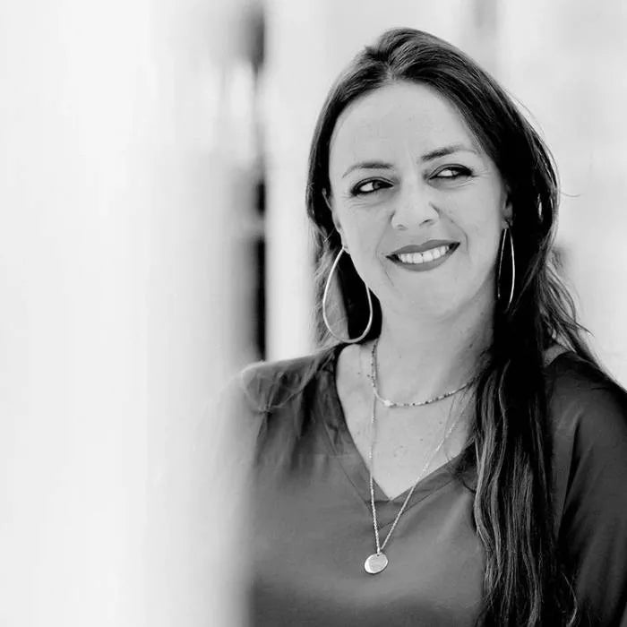 Black and white portrait of a woman with long hair and hoop earrings.